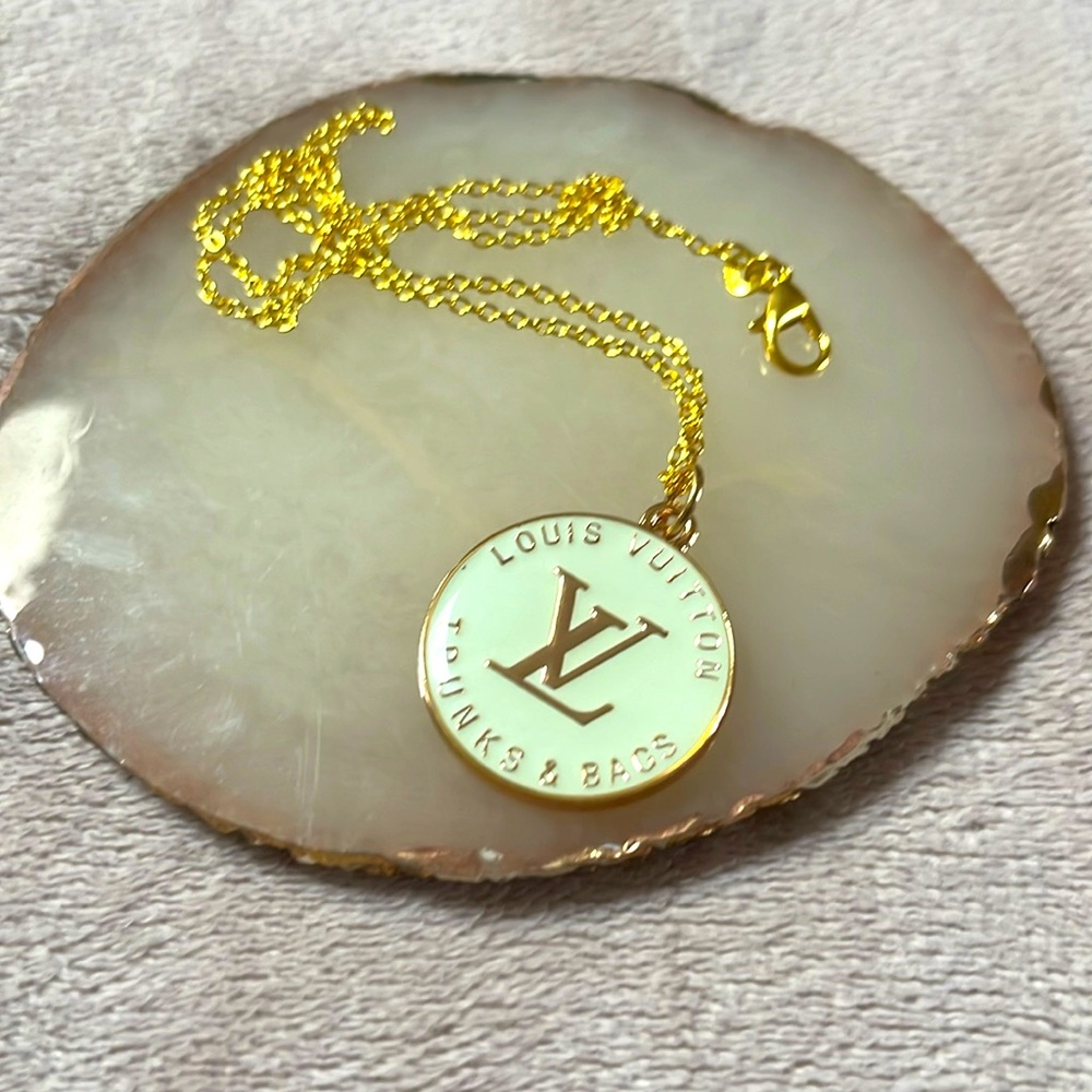 Repurposed Louis Vuitton charm into a necklace.